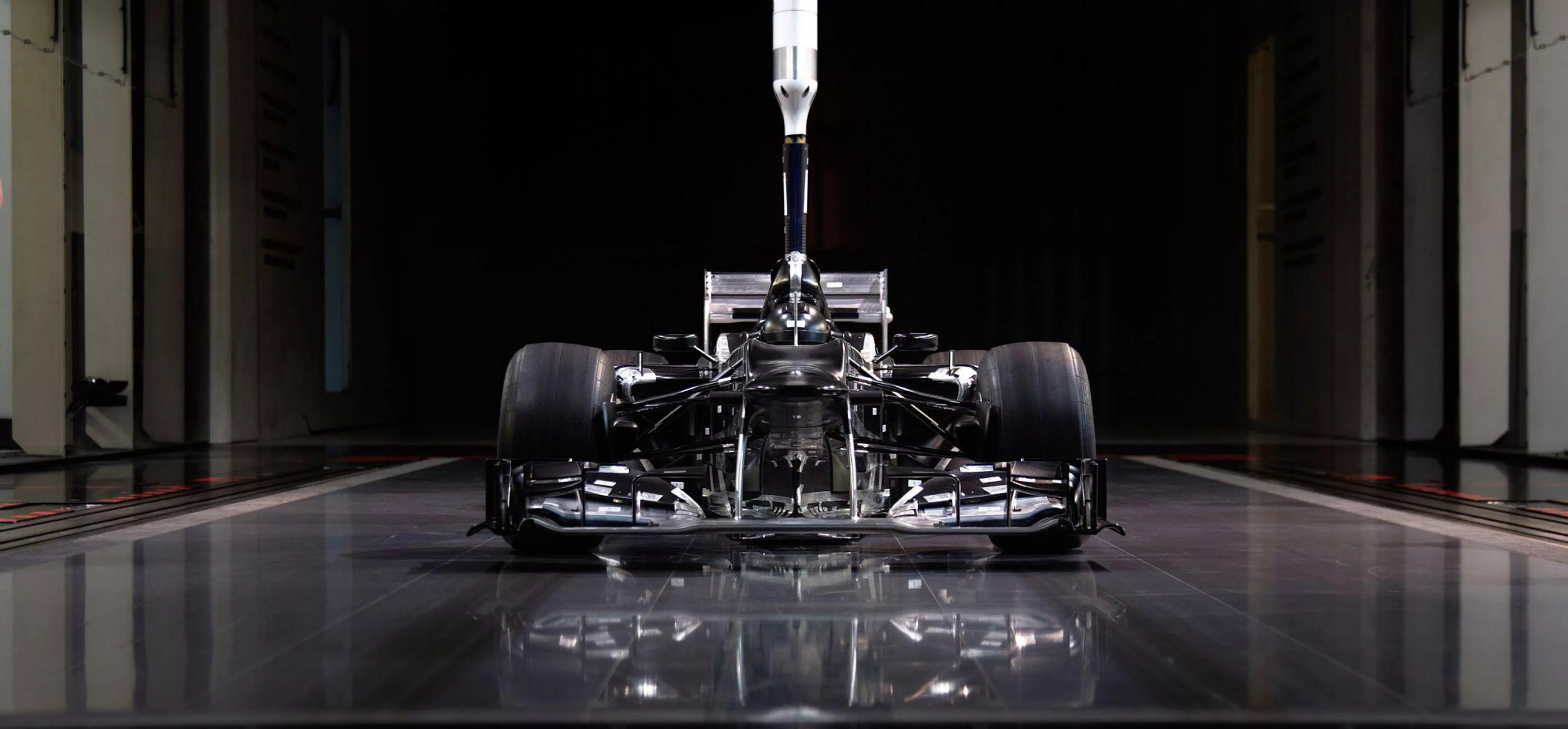 A scale-model of a Mercedes Formula 1 car in a wind tunnel. The F1 technical regulations allow for a 60% scale model of a car to be used for wind tunnels