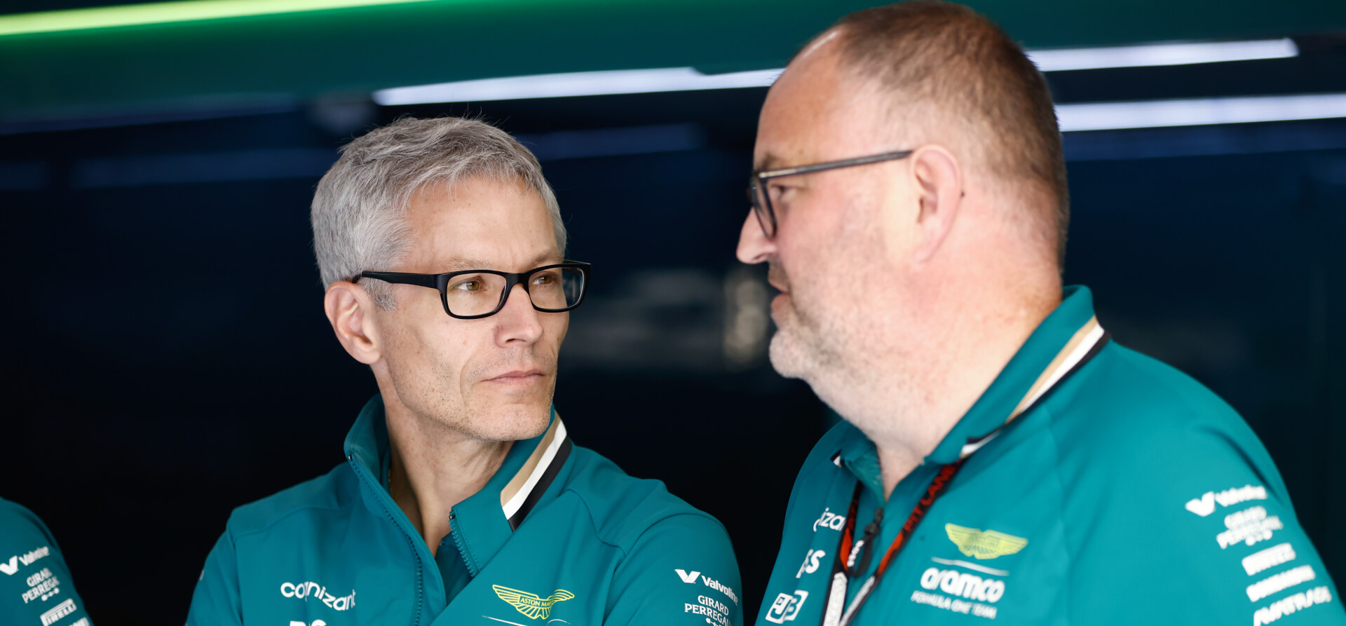 Two men wearing glasses and green F1 uniform