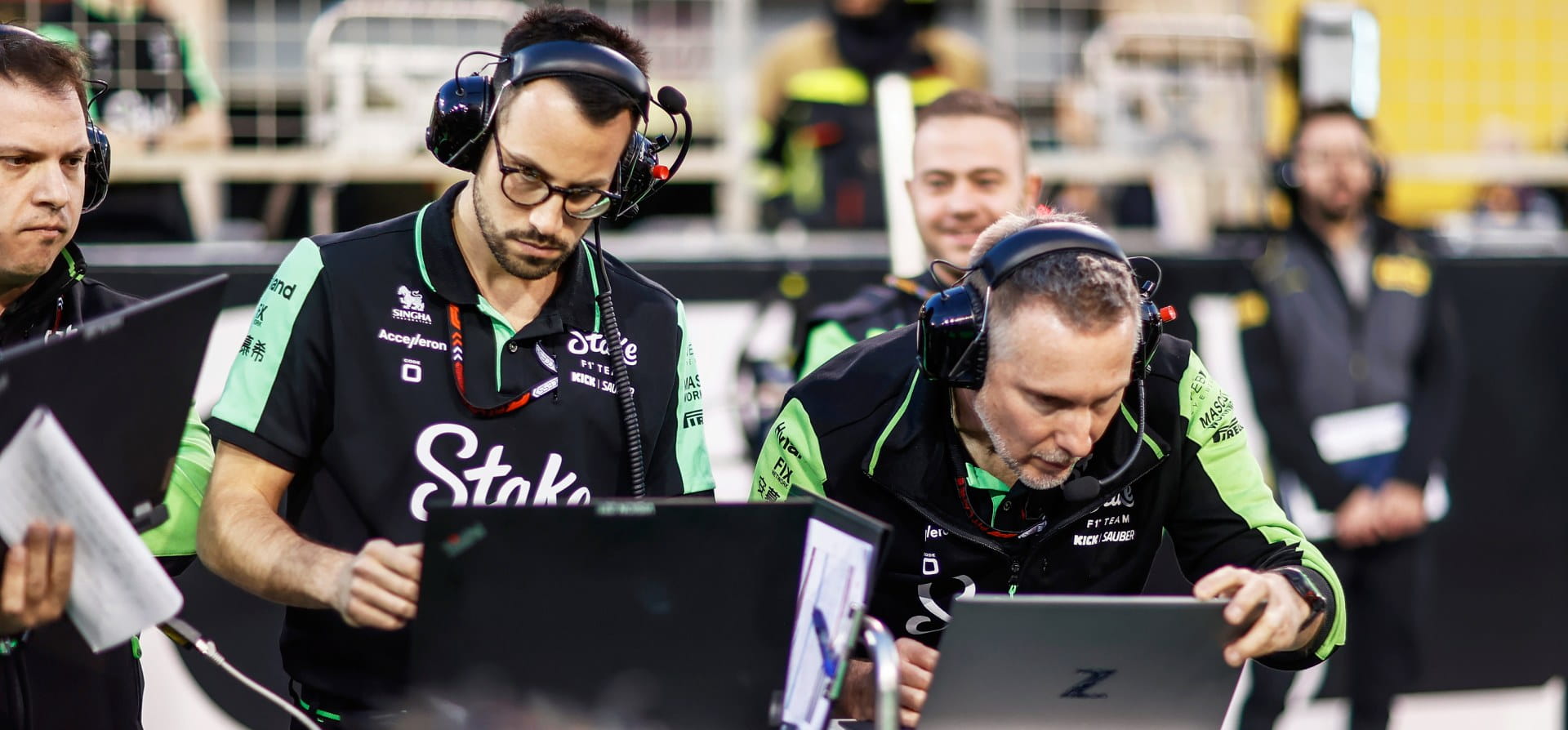 engineers looking at a computer during pre-season testing 2024