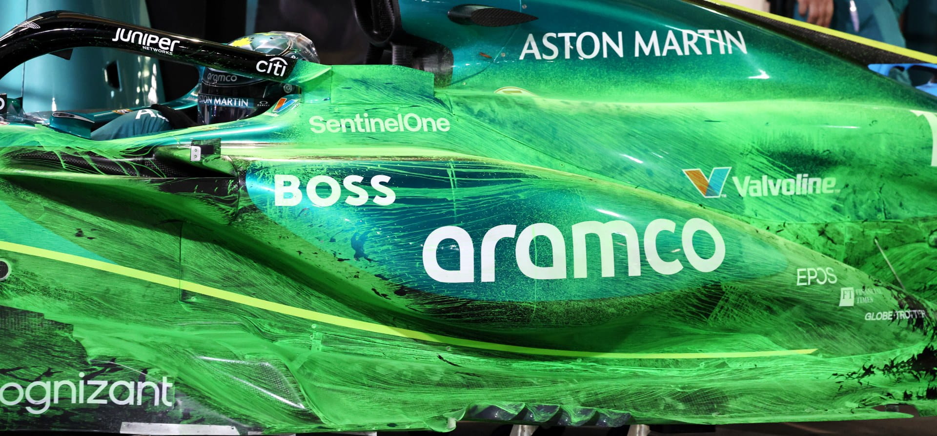 Green Aston Martin Aramco 2024 F1 car with lime green aero paint all along its left side