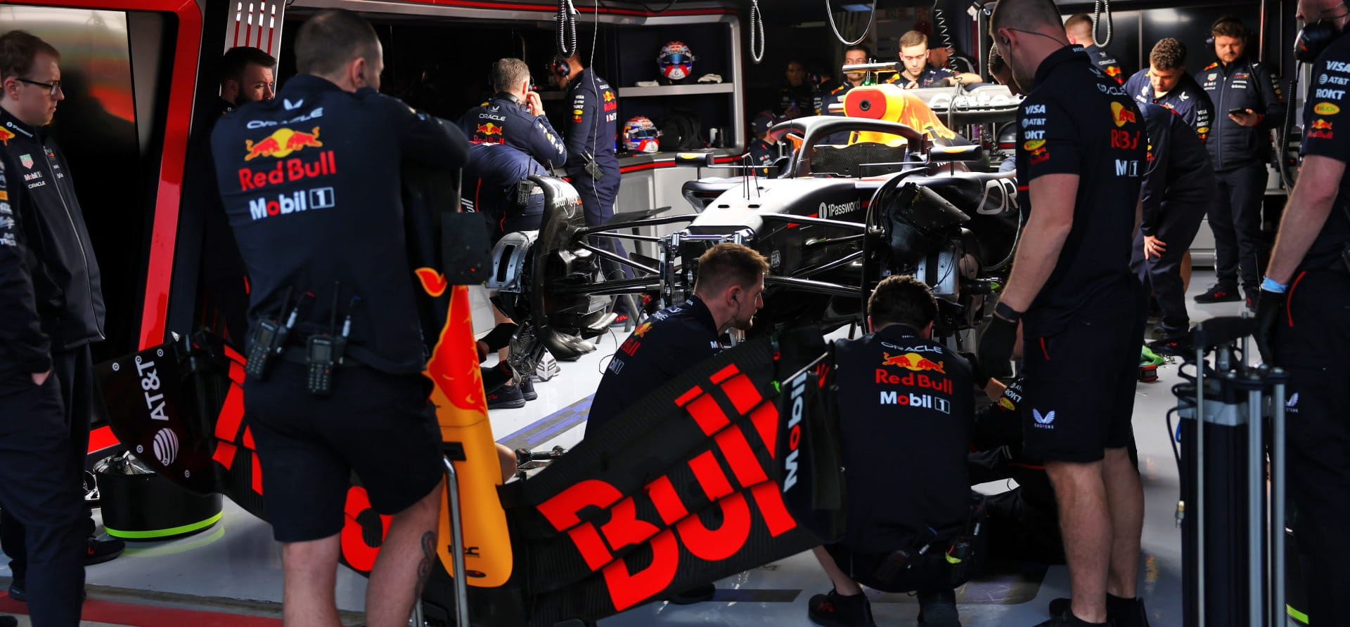 Red Bull mechanics working in garage at Bahrain during 2025 F1 preseason testing, during a powercut