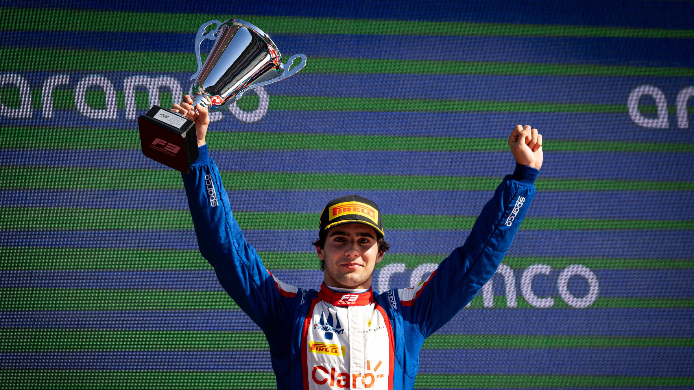 Rafael Camara holding trophy with hands in the air